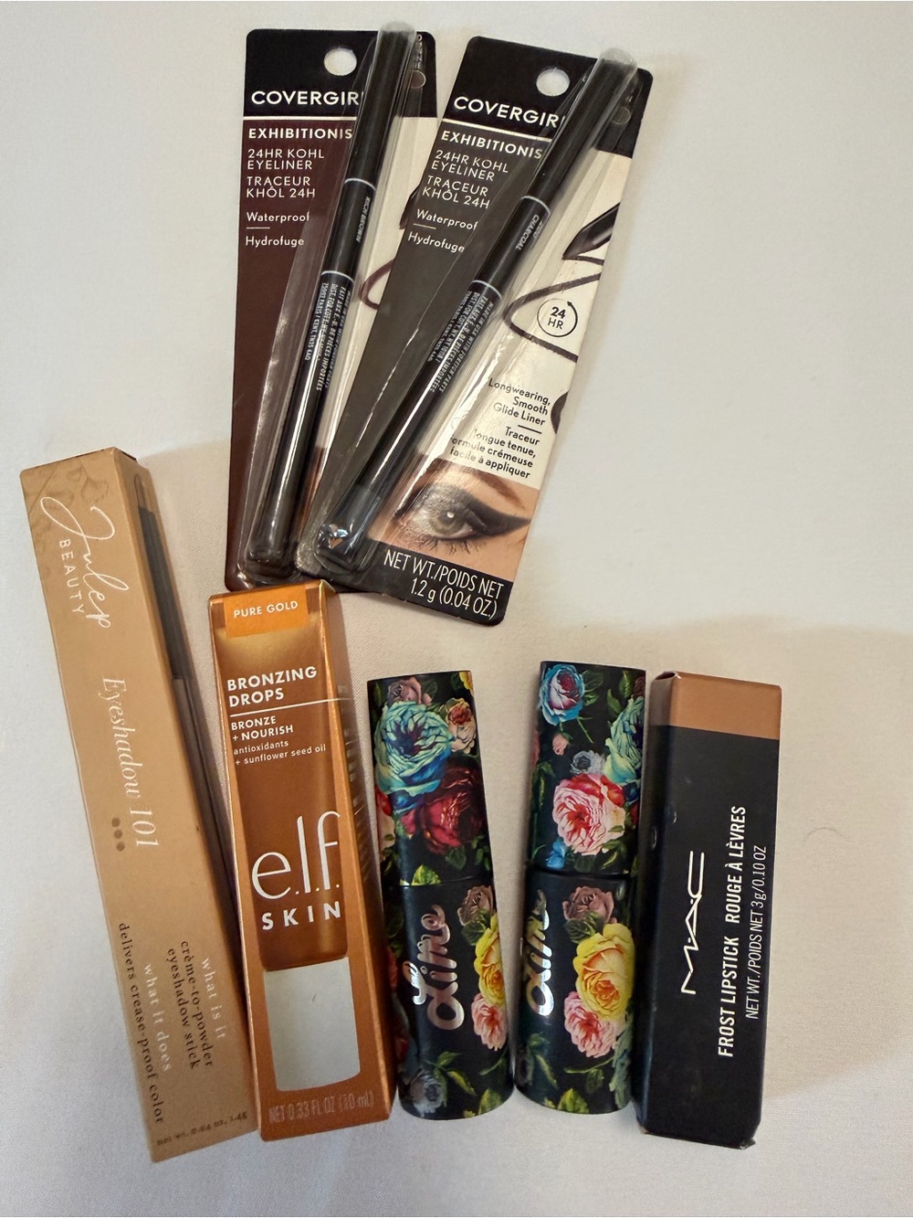 Assortment of women’s lipsticks, eyeliner, eyeshadow, bronzing drops